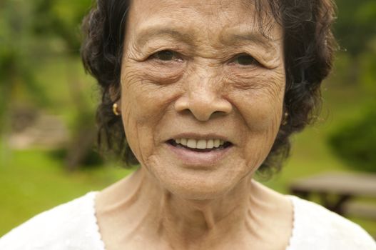 80's Asian senior woman at park in a morning