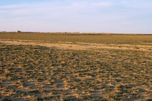Steppe landscape, far away on the horizon, industrial facilities Petrochemical industry.