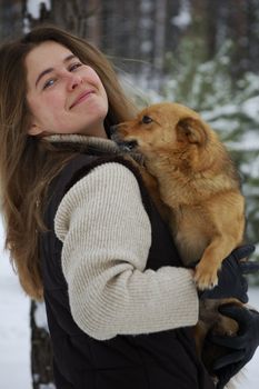 girl and a white dog in winter forest