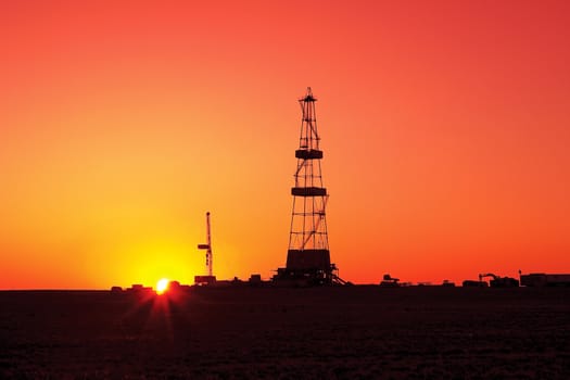 Drilling rig at sunset the sun. Western Kazakhstan.