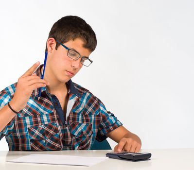 Teenager working for his maths subject with a calculator