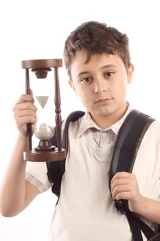 Portrait of a schoolboy with hour-glass. Time to school concept