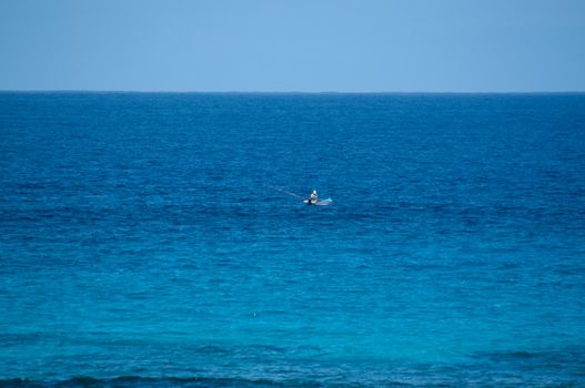 Lonely fisherman in old wooden fishing boot on Lanzarote, Canary Islands, Spain