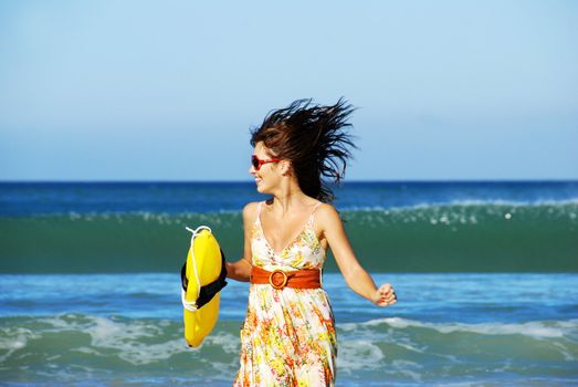 Summer girl playing on the beach