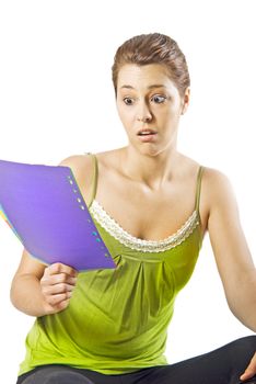 Beautiful young woman reading something shocking - white background with space for text