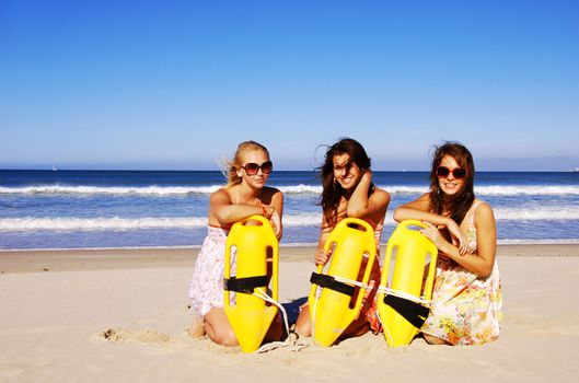 Three young woman having fun on the beach on a summer day