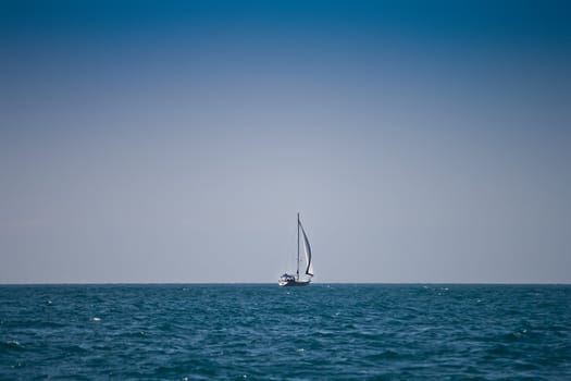 lonely sailboat in deep sea