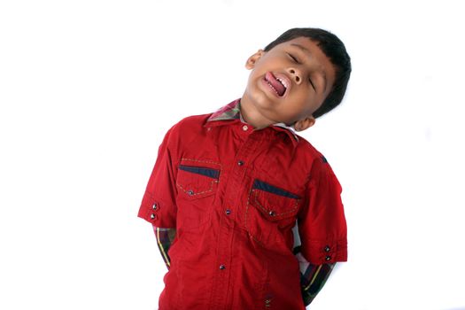 A young Indian boy fooling around by playing dead.