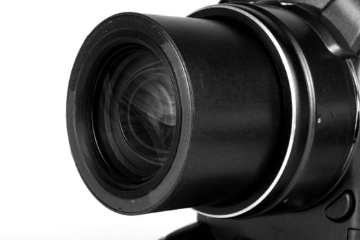 The lens of a point and shoot camera, isolated on a white studio background.