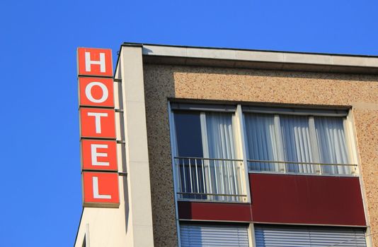 Hotel orange sign on the top side of a building by beautiful weather