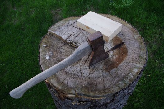 a axe on a stump of wood