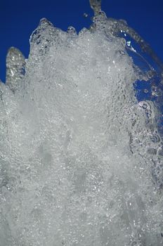 fresh water from a fountain against blue sky