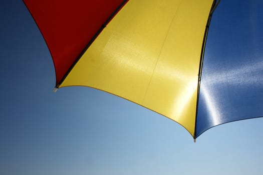 colorful parasol at the ocean on a sunny day