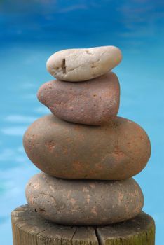 A balance group of zen stones with water background.