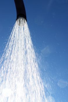 water drops falling from a shower outside