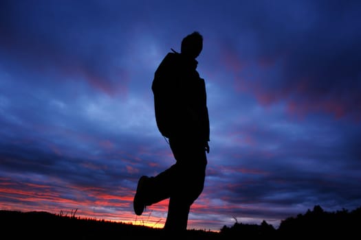 Person infront of nice clouds in the sky during the sundown