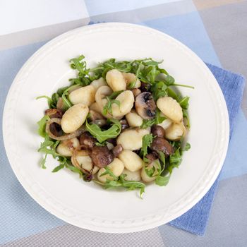 Fresh gnocchi with mushrooms, onions and fresh arugula.