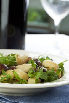 Fresh gnocchi with mushrooms, onions and fresh arugula.