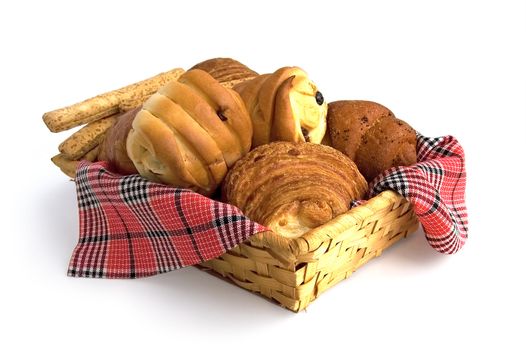 Rolls, croissants, bread sticks in a wicker basket on a red checkered napkin isolated on a white background