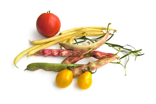 Yellow, pink, green beans with yellow and red tomatoes, green sprig tarragon isolated on a white background