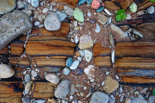 Colored small pebbles on the coast sea