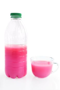 A plastic bottle and glass cup srozovym drink from whey and juice isolated on a white background