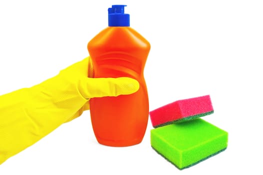 A bottle of orange with a detergent, hand in glove yellow, two sponges of green and red colors isolated on white background