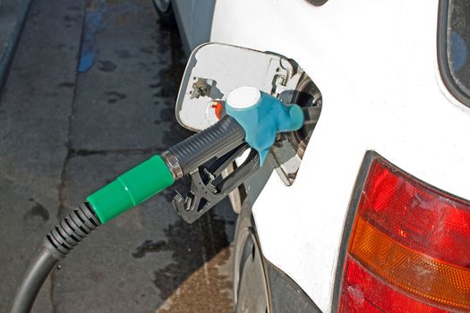 car at the gas pump, tank ready to be filled