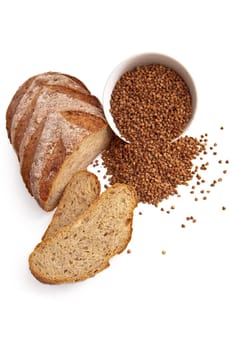 Bread, sliced, a cup of buckwheat, buckwheat on the table isolated on white background