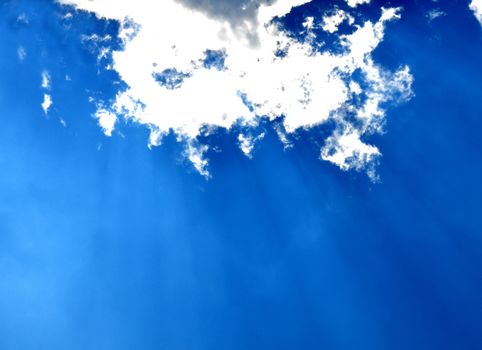 Blue sky with clouds and sun rays