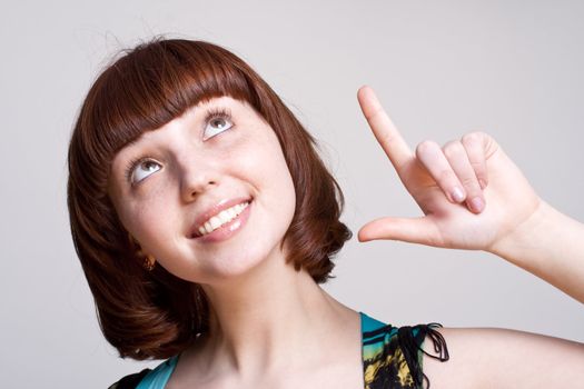 laughing girl in a dress on a gray background