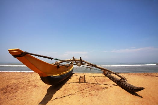 Fishing boat on a deserted coast. Sri Lanka (Ceylon)