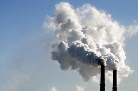 industrial smoke from chimney on blue sky