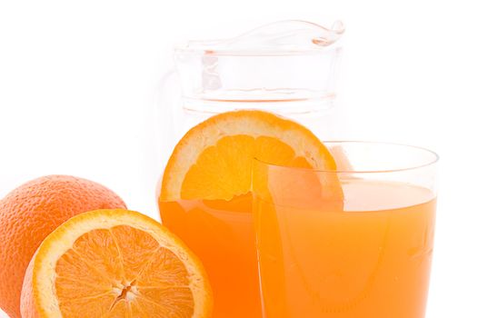 Orange juice in jug and glass over white