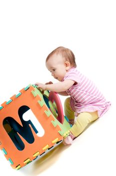 Shot of little cute baby playing with letters