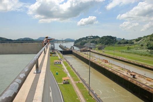 PANAMA-SEPTEMBER 10. Security Officer shows the canal to tourists on September 10, 2006 in Panama Canal. Six new locks will be constructed by 2015 on the Panama Canal.