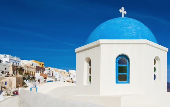 One of the famous blue dome chapels in the village of Oia, Santorini, Greece