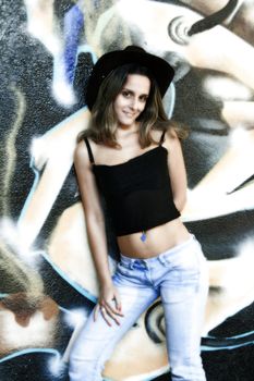 cowboy fashion girl in graffiti background