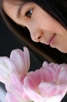 Child holding pink tulips. Part Scandinavian,Thai background