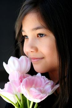Child holding pink tulips. Part Scandinavian,Thai background