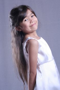 Beautiful child in white satin gown