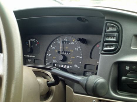 A speedometer on a dashboard of a moving car, reads 39 miles.