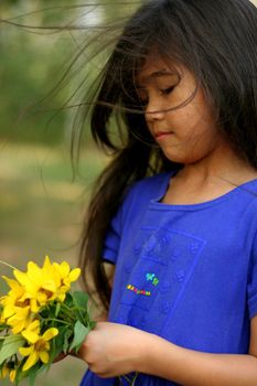 Little girl holding bouquet of sunflowers