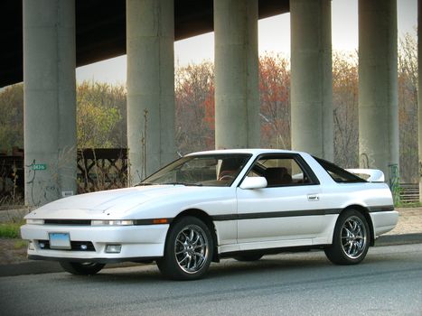 A custom import sports car parked on the side of the road.