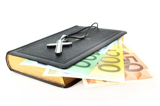 Euro note, song book and cross on a white background