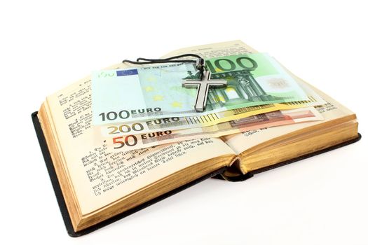 Euro note, song book and cross on a white background