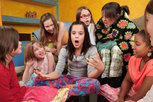 Excited girl talking with her friends at a sleepover