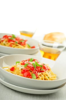 Linguini topped with fresh ripe tomatoes and herbs.