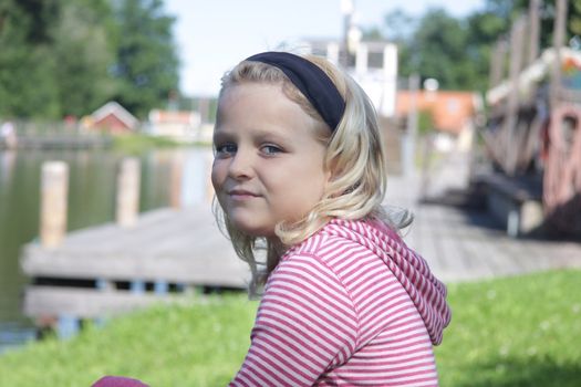 Portrait of a young girl sitting next to Gota Canale in Sweden