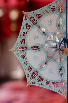 Detail of a souvenir lace umbrella, from the open market in the fishing village Marsaxlokk, a major tourist destination in Malta